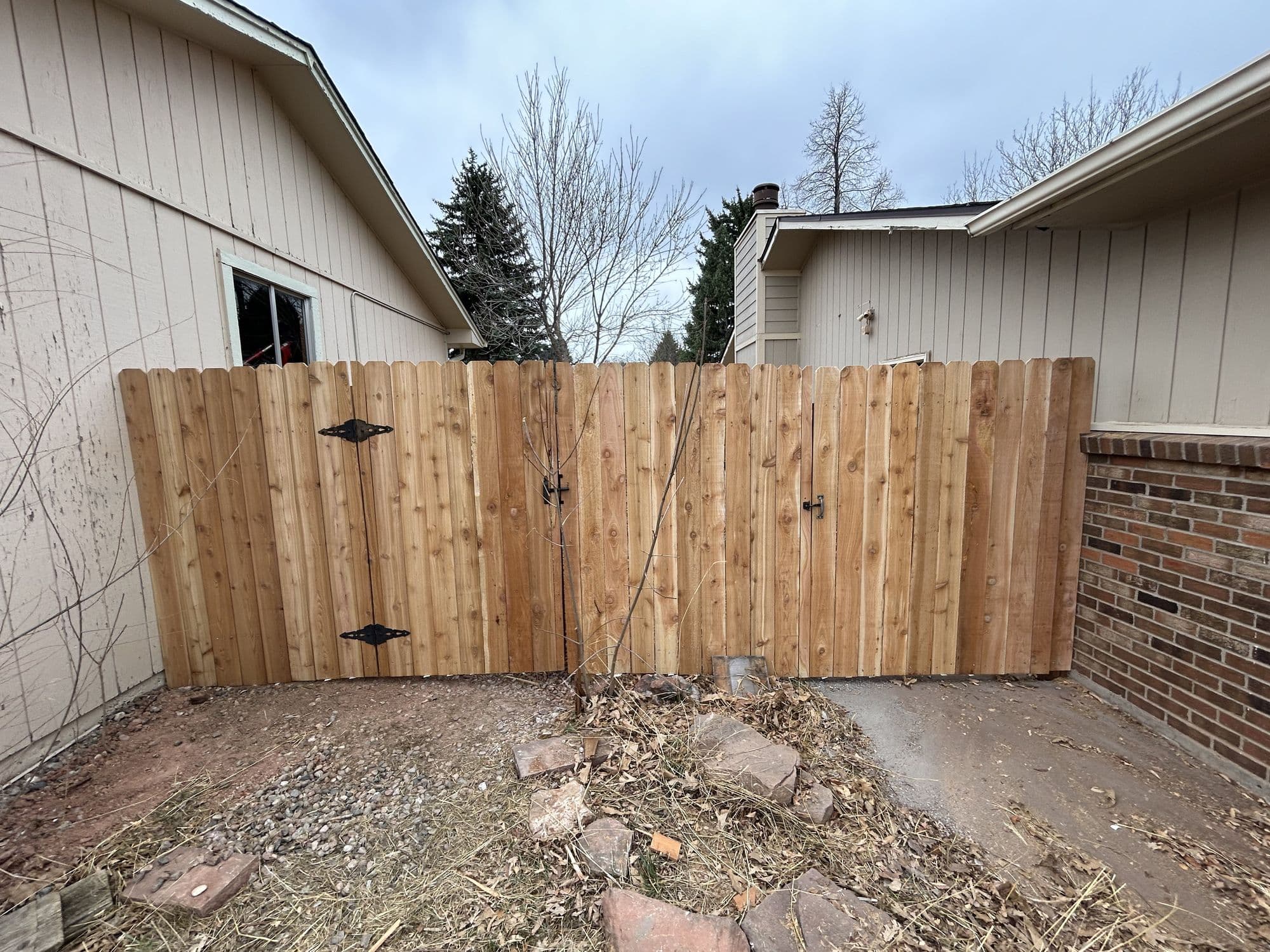 New wood privacy fence and gate installed along a Northern Colorado backyard