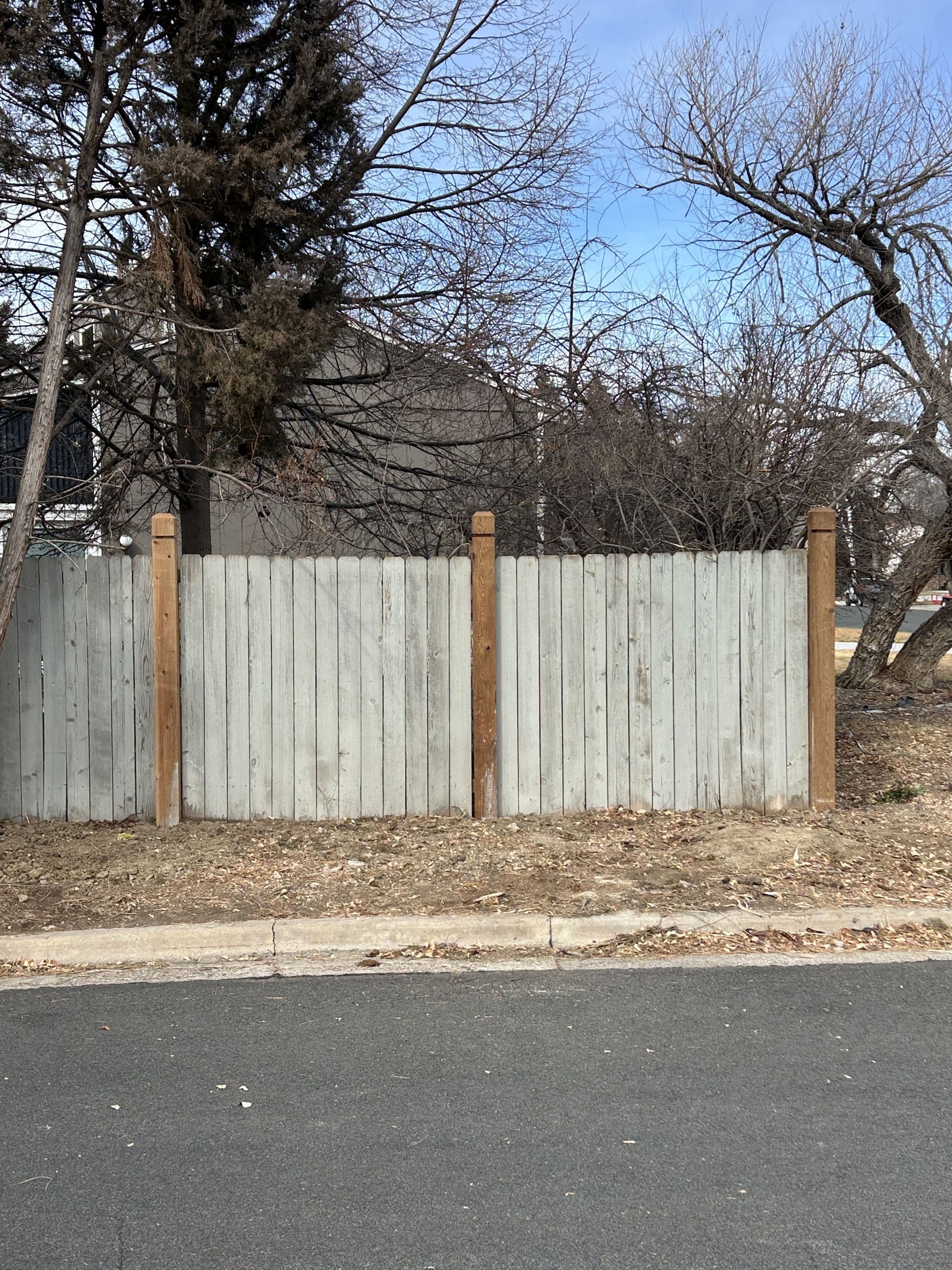 Repaired fence line with new posts and panels
