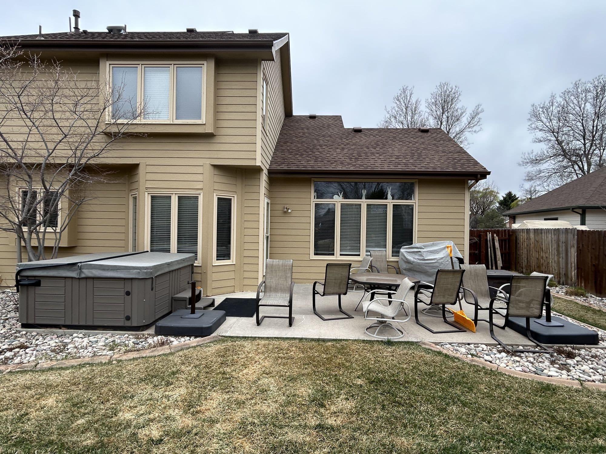 Home exterior with new siding and a deck, finished project