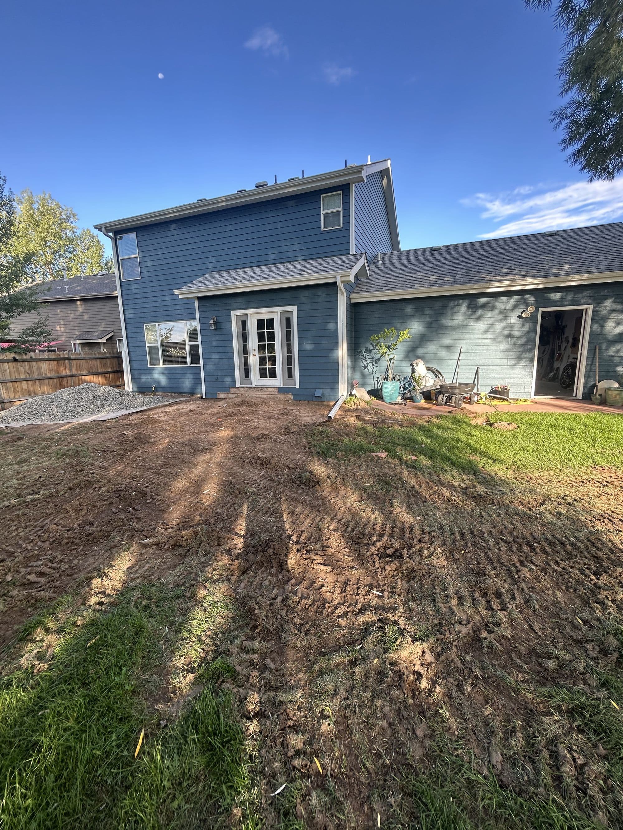 Bare yard before a large deck build