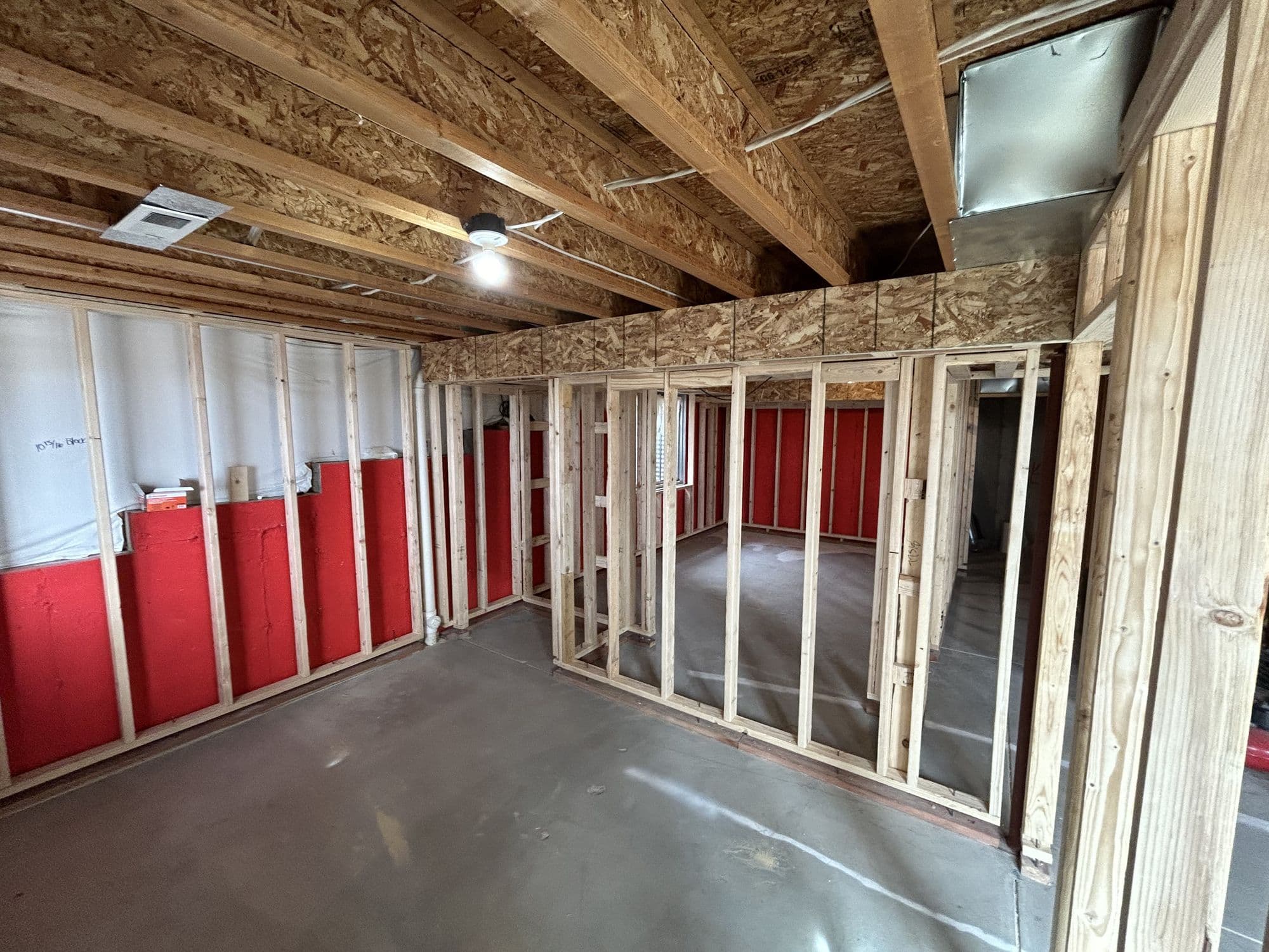Interior wall framing with insulation during a basement finish