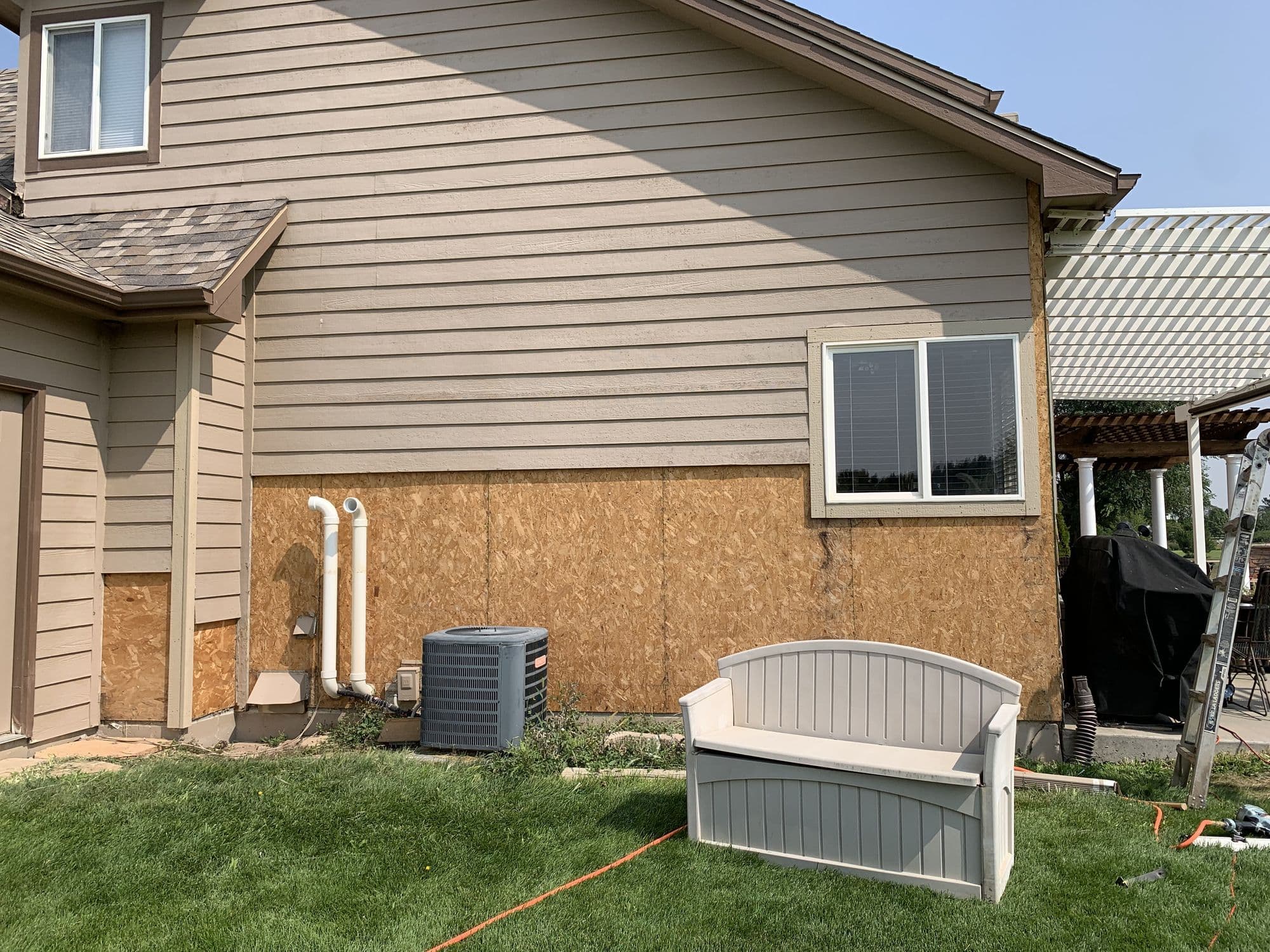 Siding repair in progress, new sheathing installed before new siding