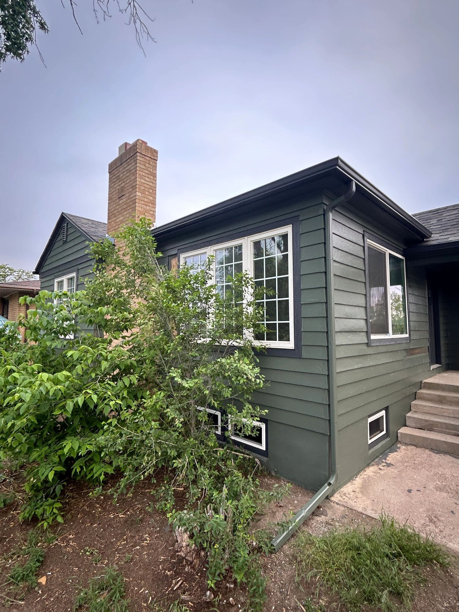 Home exterior with new siding and replacement windows